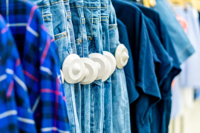 Garments in a store with security tags attached